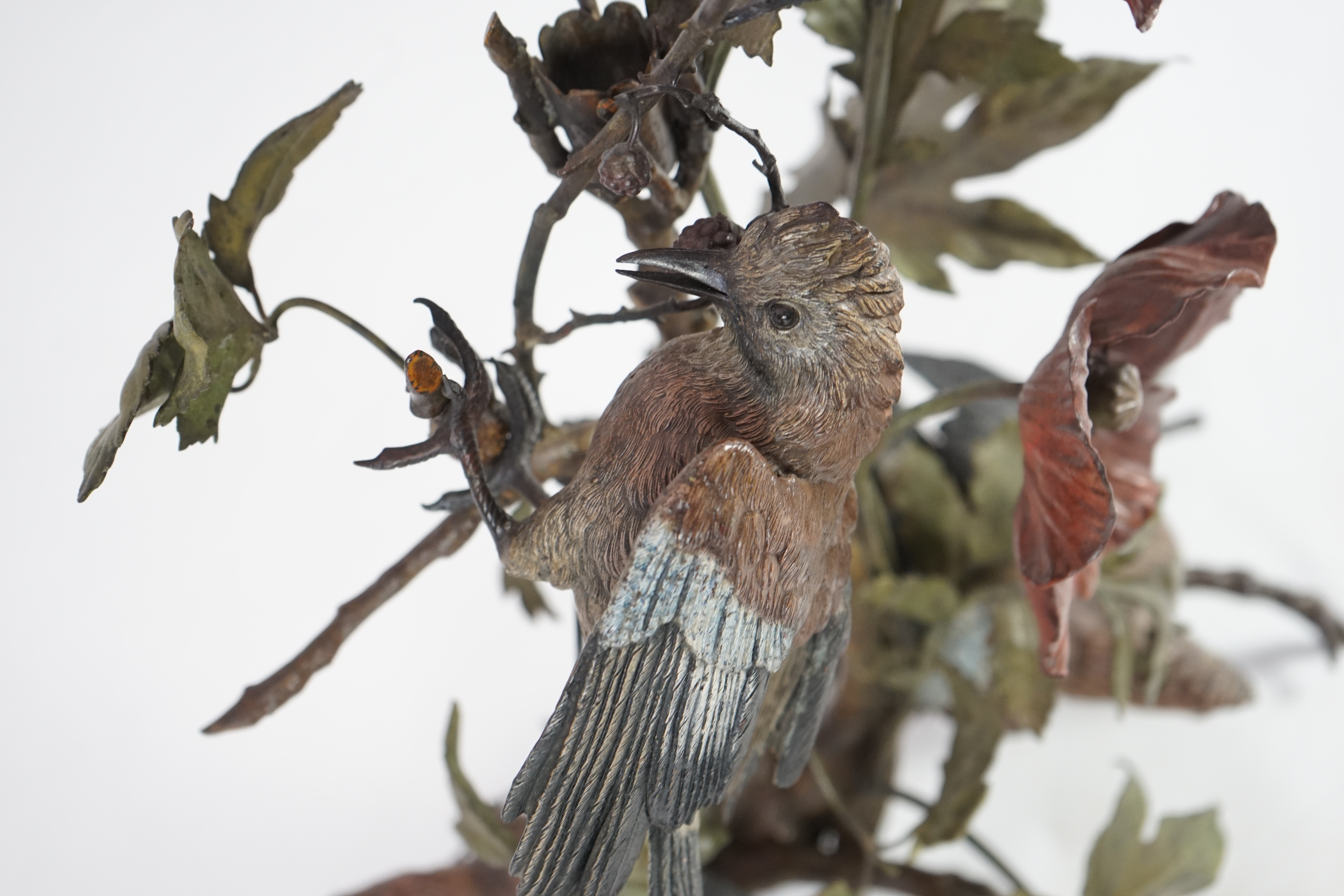 An impressive late 19th century Austrian cold painted bronze group of three jays perched amongst branches